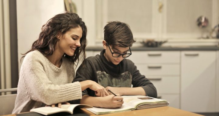 older sister helping her teenage brother to study