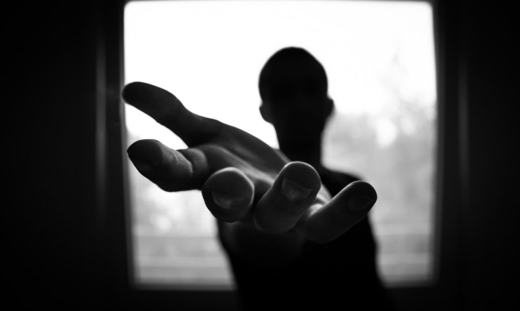 teenager stretching his hands for help