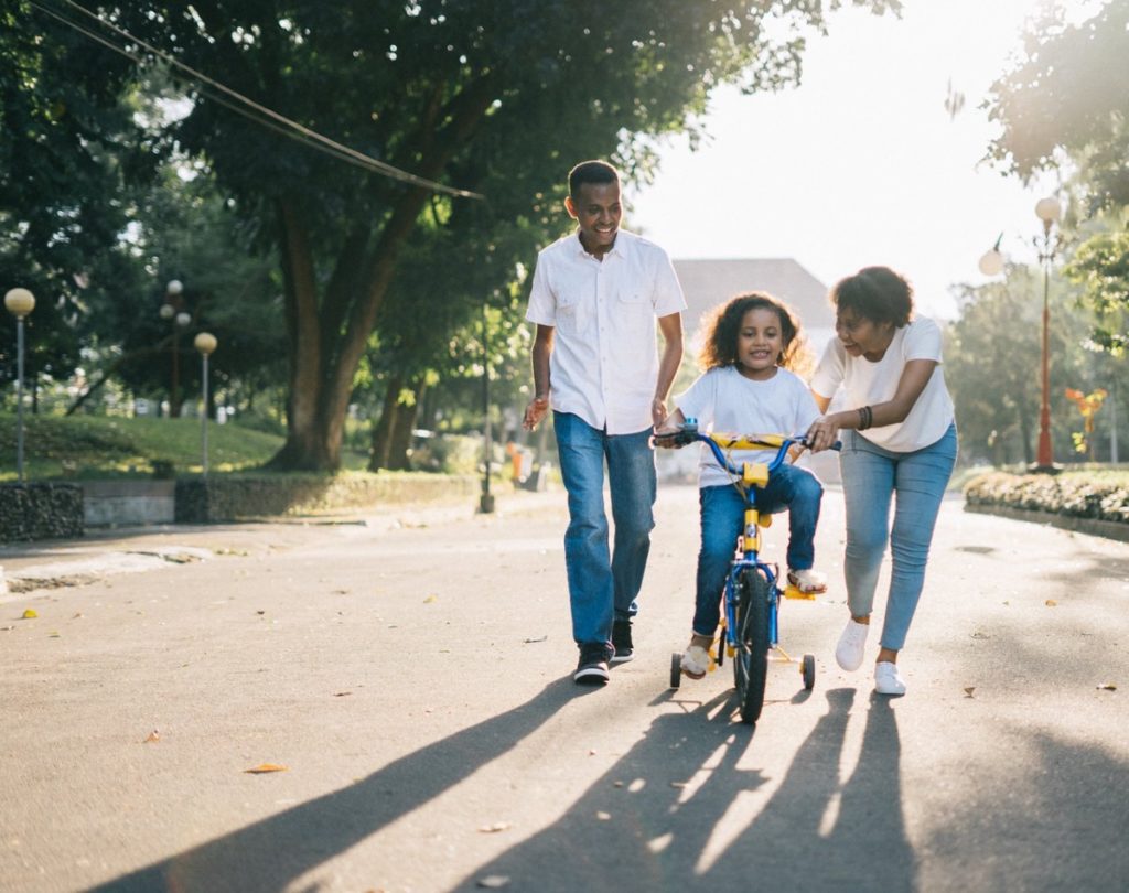 child learning to ride a bicycle