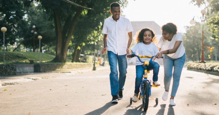 child learning to ride a bicycle