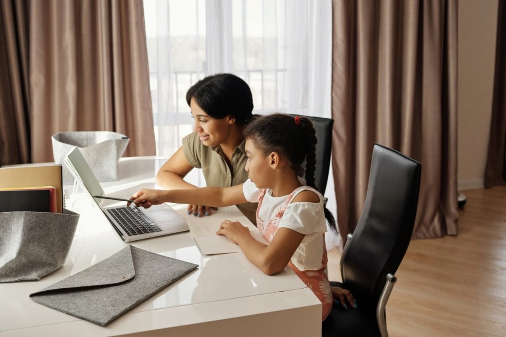 A mother teaches her child using home schooling methods.