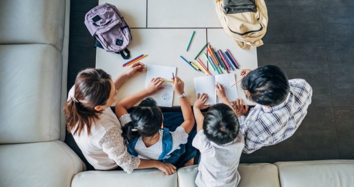 A parent teaches her children from home.