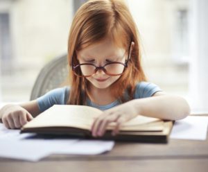a child reading a book.