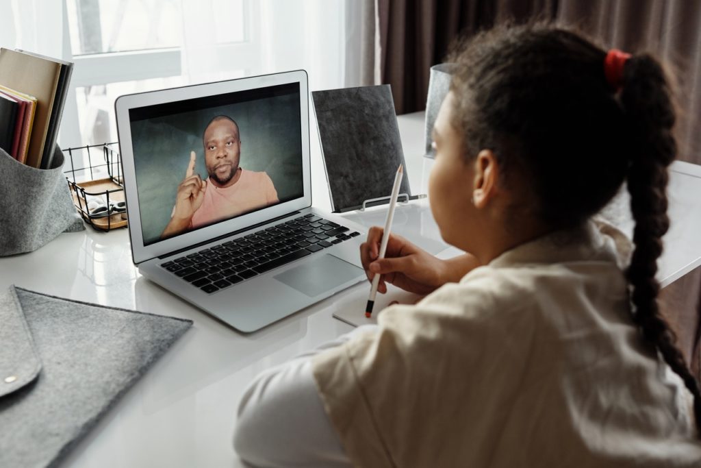 A school child having an online lesson through the laptop.